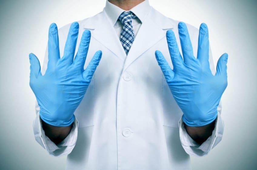 A doctor wearing blue latex gloves
